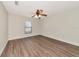 Bedroom with a ceiling fan, one window, and wood-look flooring at 26147 L And J Rd, Myakka City, FL 34251