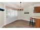 Charming dining area features a stylish chandelier, wood flooring, and a bright window with a picturesque view at 26147 L And J Rd, Myakka City, FL 34251