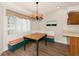 Cozy dining nook featuring a built-in bench and a chandelier at 26147 L And J Rd, Myakka City, FL 34251