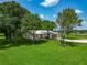 Lush landscaping surrounds this charming one-story home with a brick driveway and attached garage at 26147 L And J Rd, Myakka City, FL 34251