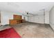 Spacious garage featuring a large workbench, ample storage, and an automatic garage door at 26147 L And J Rd, Myakka City, FL 34251