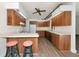Well-lit kitchen features wood cabinets, modern appliances, and a convenient breakfast bar with stylish stools at 26147 L And J Rd, Myakka City, FL 34251