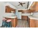 Well-lit kitchen features wood cabinets, modern appliances, and a convenient breakfast bar with stylish stools at 26147 L And J Rd, Myakka City, FL 34251
