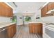 Bright eat-in kitchen features wood cabinets and modern appliances, with a view into the charming dining area at 26147 L And J Rd, Myakka City, FL 34251