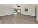 Open floor plan featuring light gray wood-look flooring, kitchen pass-through, and sliding doors to the yard at 26147 L And J Rd, Myakka City, FL 34251
