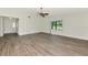 Spacious room with light gray wood-look flooring and a large window with views of the front yard at 26147 L And J Rd, Myakka City, FL 34251