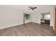 Spacious main bedroom with wood flooring, a ceiling fan, and an en-suite bathroom featuring wood cabinets at 26147 L And J Rd, Myakka City, FL 34251