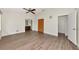Spacious main bedroom with wood flooring, a ceiling fan, a closet, and an en-suite bathroom featuring wood cabinets at 26147 L And J Rd, Myakka City, FL 34251