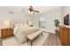 Serene main bedroom with a plush bed, bench, neutral decor, and ample natural light from a bright window at 26147 L And J Rd, Myakka City, FL 34251