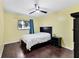 Bedroom with yellow walls, ceiling fan, and wood floors at 2866 E Rainbow Cir, Sarasota, FL 34231