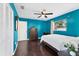 Bedroom with blue walls, ceiling fan, hardwood floors, and closet at 2866 E Rainbow Cir, Sarasota, FL 34231