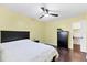 Bedroom with yellow walls, ceiling fan, and wood floors at 2866 E Rainbow Cir, Sarasota, FL 34231