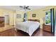 Bedroom with yellow walls, ceiling fan, and wood floors at 2866 E Rainbow Cir, Sarasota, FL 34231