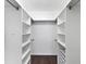 Walk-in closet with built-in shelving and hardwood floors at 2866 E Rainbow Cir, Sarasota, FL 34231