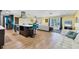 Open concept living area with an eat-in kitchen island and white couches with decorative pillows at 2866 E Rainbow Cir, Sarasota, FL 34231