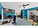 Office space with blue walls, ceiling fan, adjacent to a kitchen and sliding glass doors at 2866 E Rainbow Cir, Sarasota, FL 34231