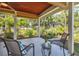 Relaxing covered outdoor seating area with views of lush landscaping at 2866 E Rainbow Cir, Sarasota, FL 34231