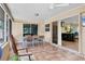 Screened patio with tile flooring and a view through the glass door to the open kitchen area at 2866 E Rainbow Cir, Sarasota, FL 34231