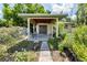 Covered patio with outdoor seating and a well-manicured garden at 2866 E Rainbow Cir, Sarasota, FL 34231