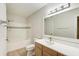 Bathroom with tub shower combo, white tile, white cabinets, and wood-look floors at 3005 Chianti Ct # 103, Sarasota, FL 34237