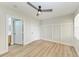Bedroom featuring a ceiling fan, wood-look floors, neutral paint and many doors at 3005 Chianti Ct # 103, Sarasota, FL 34237