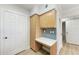 Hallway desk area features white counters, light wood cabinetry, and blue backsplash at 3005 Chianti Ct # 103, Sarasota, FL 34237