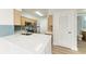 Kitchen featuring a stylish subway tile backsplash, quartz countertops, and new vinyl flooring at 3005 Chianti Ct # 103, Sarasota, FL 34237