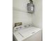 Laundry room includes a white top load washing machine with shelving above at 3005 Chianti Ct # 103, Sarasota, FL 34237