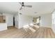 Living room featuring a ceiling fan, laminate flooring, and sliding glass door to the outside at 3005 Chianti Ct # 103, Sarasota, FL 34237