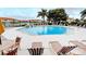Community pool with surrounding lounge chairs and well-maintained landscaping at 3005 Chianti Ct # 103, Sarasota, FL 34237