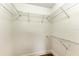 Empty walk-in closet with white walls and metal shelving on 3 sides at 3005 Chianti Ct # 103, Sarasota, FL 34237
