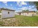 Backyard view showcasing house and shed at 3211 Deerfield Dr, Tampa, FL 33619