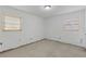 This bedroom features neutral walls, two windows and a concrete floor at 3211 Deerfield Dr, Tampa, FL 33619