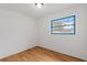 Cozy bedroom featuring wood floors, neutral walls, and a bright window at 3211 Deerfield Dr, Tampa, FL 33619