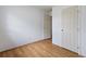 Bedroom with light hardwood floors, two doors, white walls, and natural light at 3211 Deerfield Dr, Tampa, FL 33619