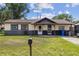 Charming single-story home with a well-maintained lawn and inviting front porch at 3211 Deerfield Dr, Tampa, FL 33619
