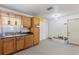 Kitchen with stainless steel sink, wood cabinets and updated fixtures ready for finishing at 3211 Deerfield Dr, Tampa, FL 33619