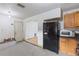 Kitchen with black refrigerator and stainless steel microwave ready for renovation at 3211 Deerfield Dr, Tampa, FL 33619