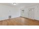 Bright living room featuring hardwood floors, a window, and a front door at 3211 Deerfield Dr, Tampa, FL 33619