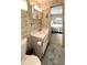 Bathroom featuring a sink, toilet, mirror, and view to the bedroom at 3224 Aspen Ter, Sarasota, FL 34237