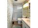 Bathroom featuring a toilet, sink, and walk-in shower with floral wallpaper at 3224 Aspen Ter, Sarasota, FL 34237