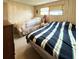Bedroom with two beds, a nightstand, wood paneling, and carpeted floors at 3224 Aspen Ter, Sarasota, FL 34237