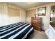 Bedroom with bed, dresser, closet, and a view into the hall at 3224 Aspen Ter, Sarasota, FL 34237