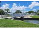 Picturesque bridge over a canal with lush landscaping and charming mobile homes in the background at 3224 Aspen Ter, Sarasota, FL 34237