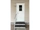 Inviting front door with a secure railing, showcasing clean lines and a neatly kept entryway for a welcoming first impression at 3224 Aspen Ter, Sarasota, FL 34237