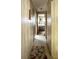 Hallway with wood-look walls that leads to a bedroom at the end at 3224 Aspen Ter, Sarasota, FL 34237
