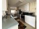 Bright kitchen featuring stainless steel appliances, light-colored cabinetry, and a double sink at 3224 Aspen Ter, Sarasota, FL 34237