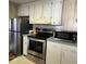 A well-equipped kitchen with stainless steel oven, microwave, and refrigerator, offering modern convenience at 3224 Aspen Ter, Sarasota, FL 34237