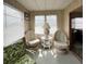 Comfortable sun room with two swivel chairs and a glass-top table offers relaxing seating at 3224 Aspen Ter, Sarasota, FL 34237