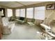 Sunroom with lots of natural light, multiple seating areas, and carpeted floors at 3224 Aspen Ter, Sarasota, FL 34237